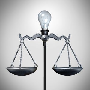 Scales of Justice with lightbulb of invention