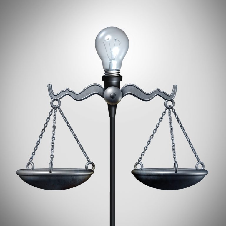 Scales of Justice with lightbulb of invention