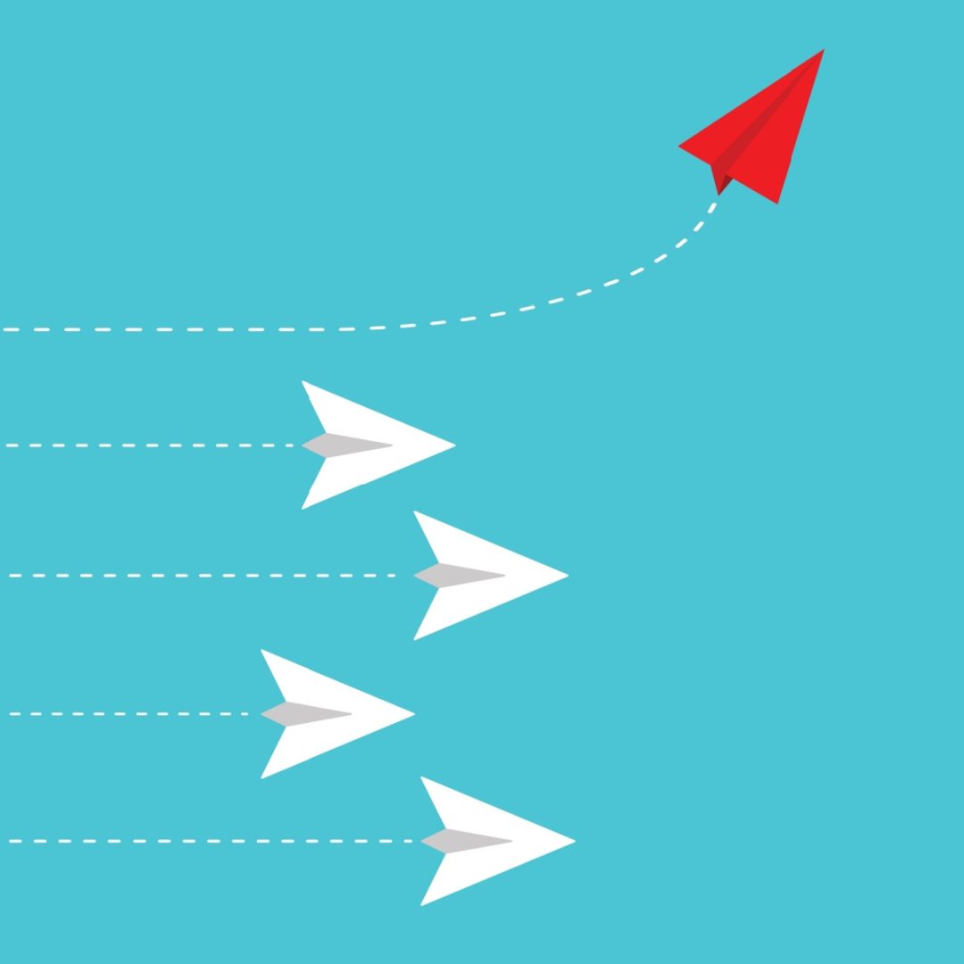 Red paper airplane changing direction